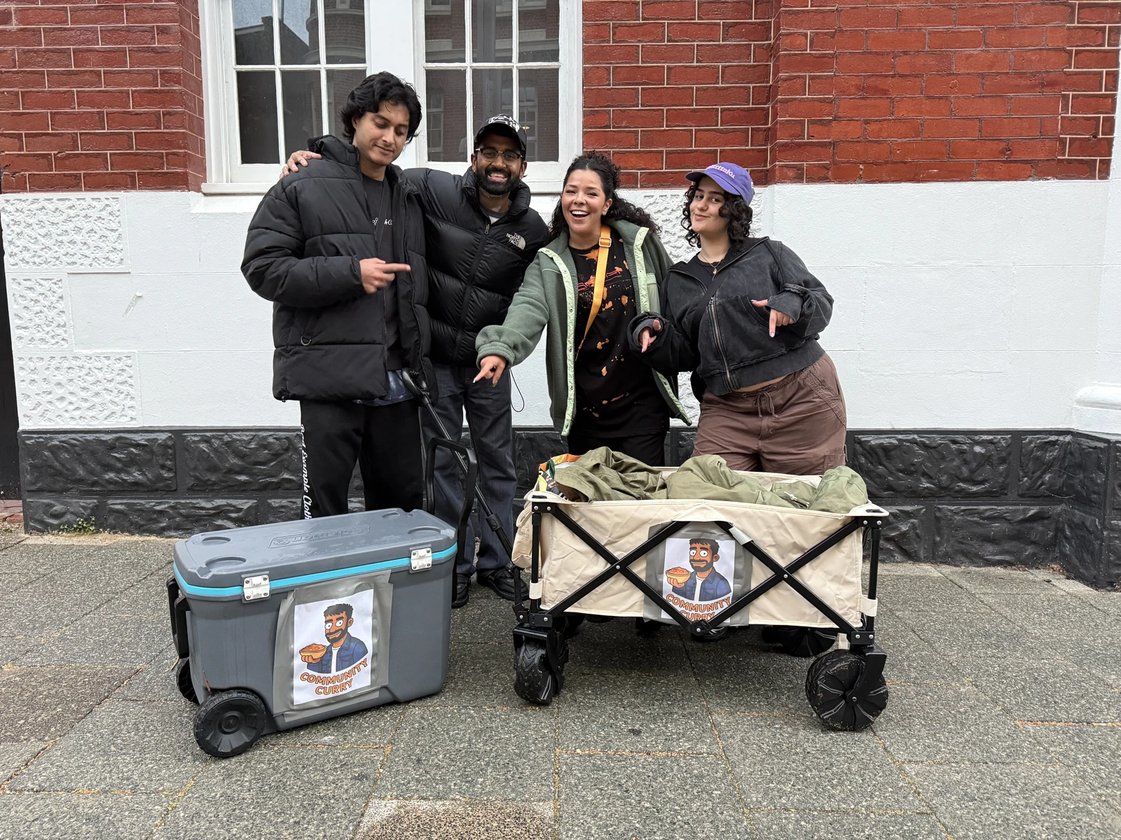 Community Curry team with their branded meal-distribution carts in Perth